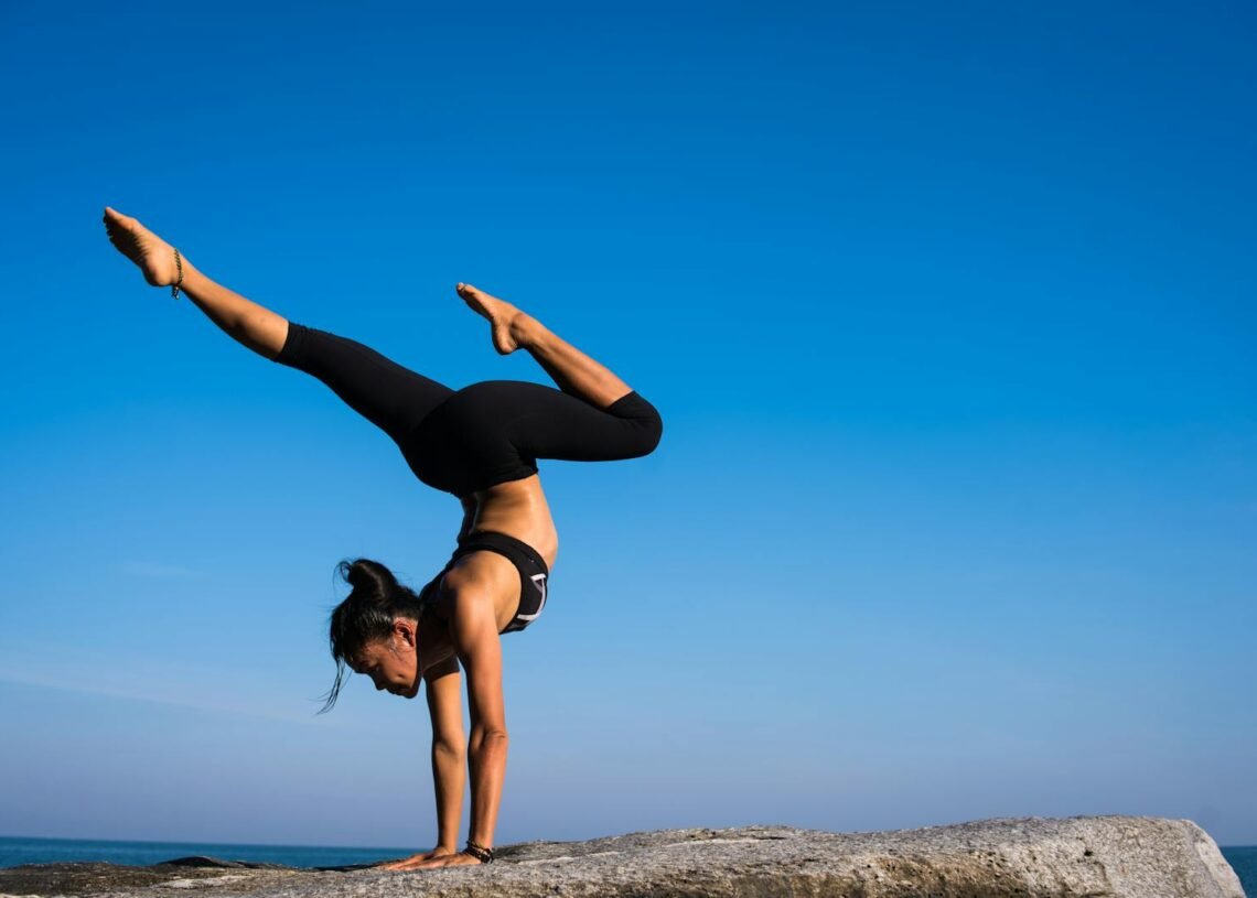 Woman With Arms Outstretched Against Blue Sky