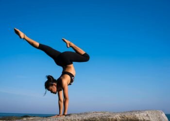 Woman With Arms Outstretched Against Blue Sky