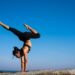 Woman With Arms Outstretched Against Blue Sky