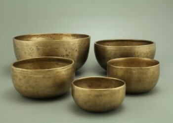 3 brown ceramic bowls on white surface