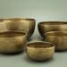 3 brown ceramic bowls on white surface