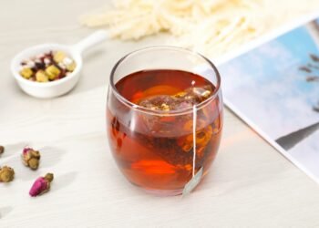 clear glass cup with brown liquid