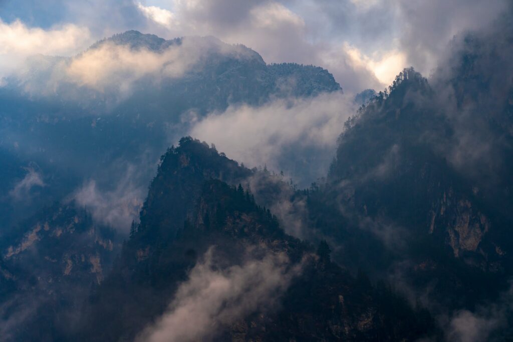 green mountain under white clouds