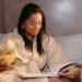 Woman Reading a Catalog While Holding a Cocktail