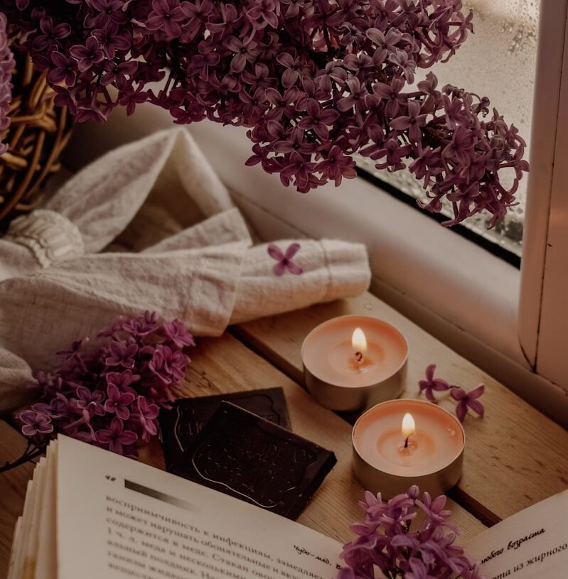 white candle beside white book