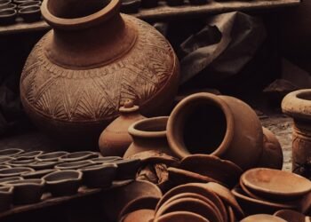 a pile of pottery sitting on top of a wooden table