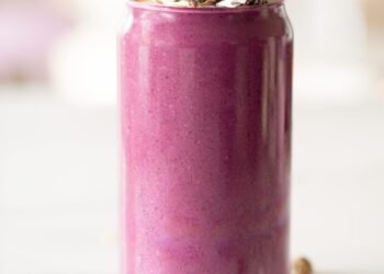 a purple smoothie in a glass with a spoon